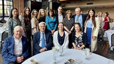 Rheumatology faculty and fellows sitting at a table together