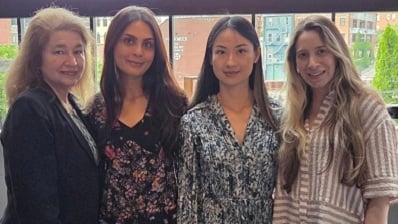 Four rheumatology fellows posing for photo in front of window