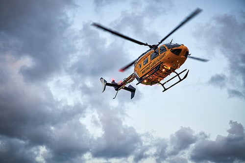 Life Flight helicopter shown against the clouds in the sky